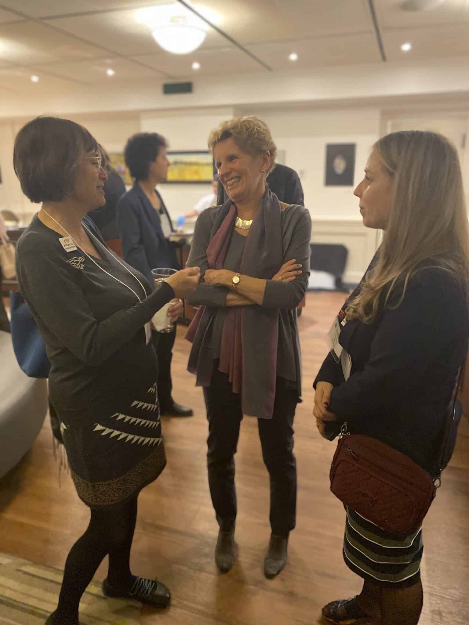 Former Premier Kathleen Wynne chats Ellen Chambers (left) and Jennifer Kitowski (right) of OPSBA's Board of Directors.