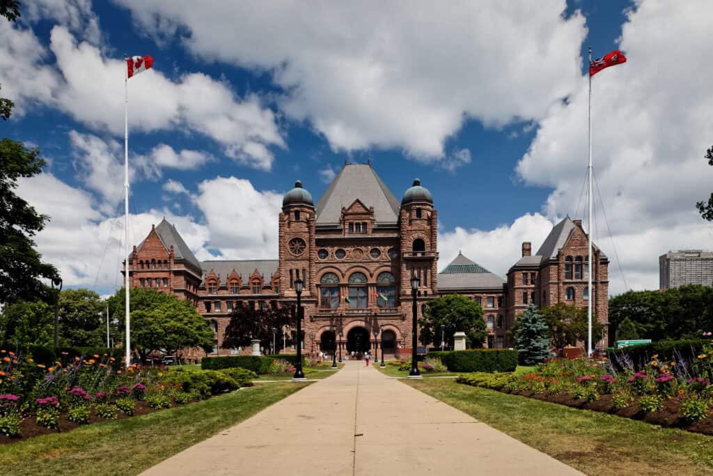 A photo of Queen's Park in Toronto from the front on a sunny day.