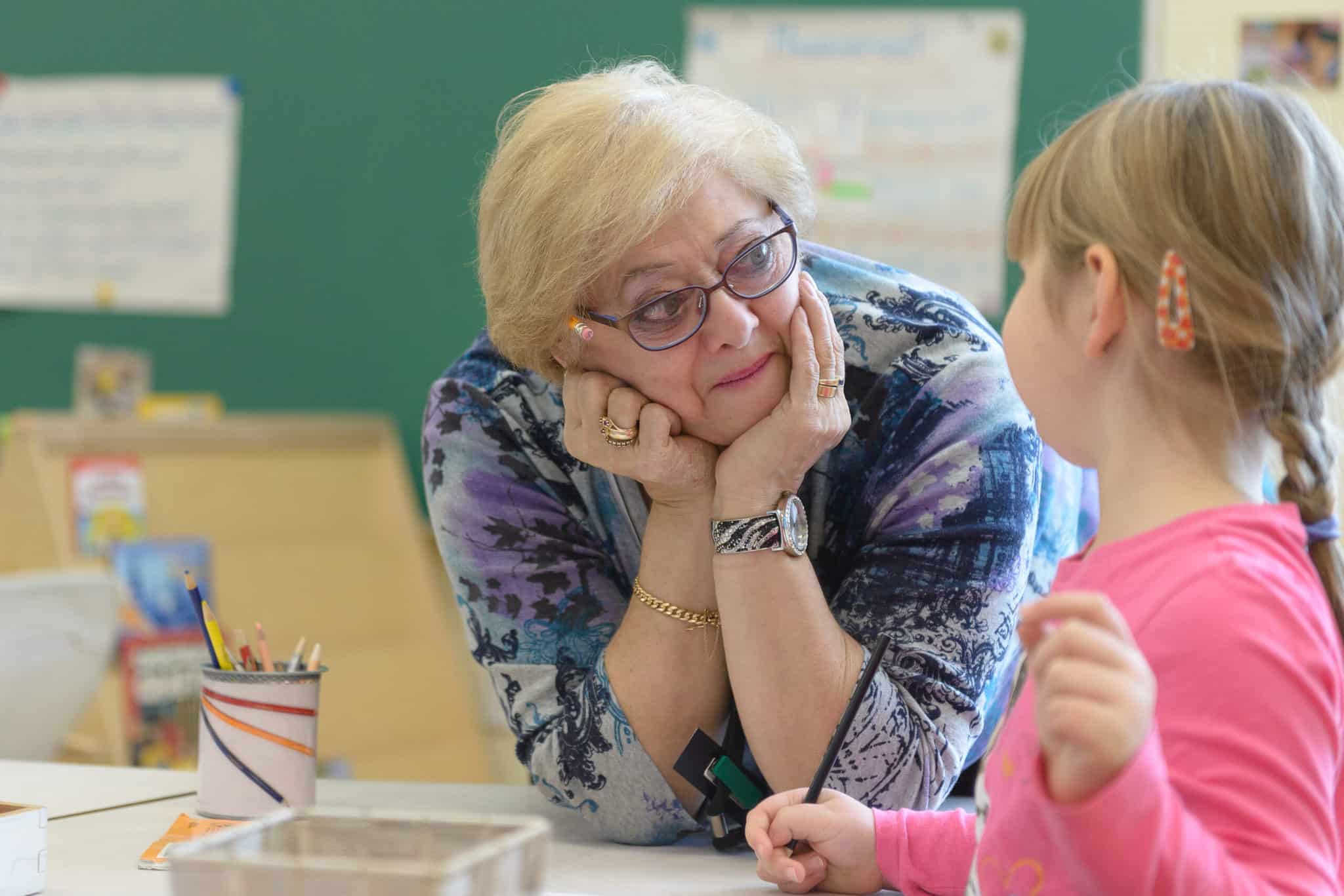 A woman listens to a student.